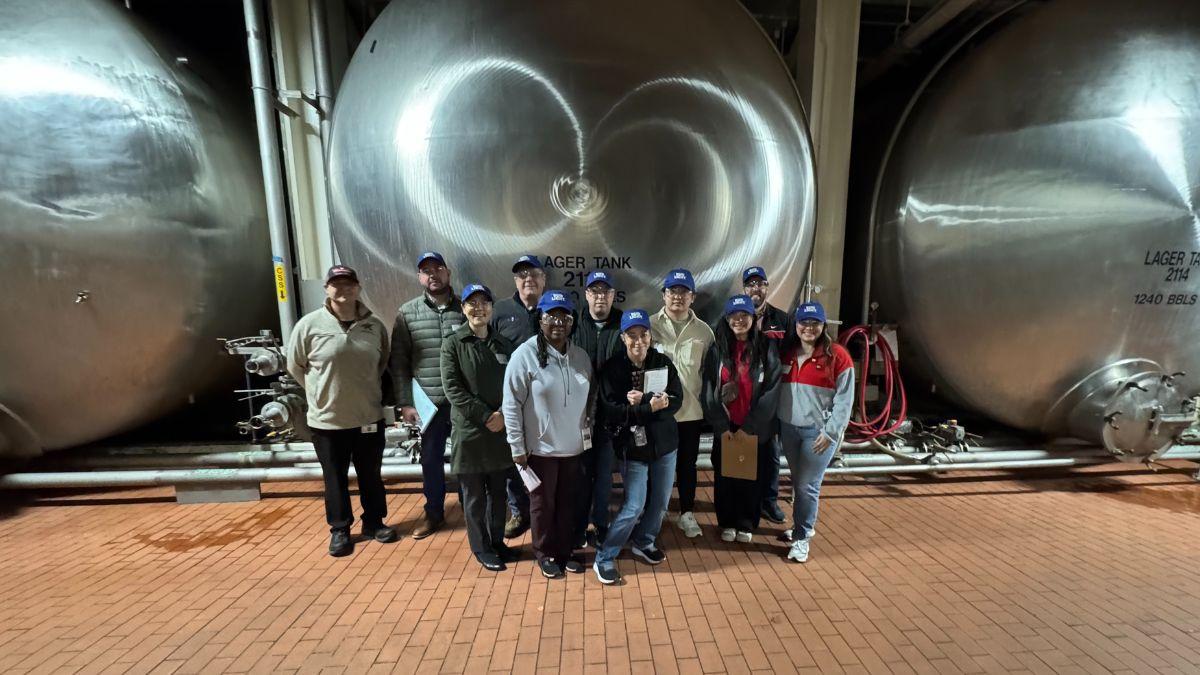 Group class photo in front of boiler tank.